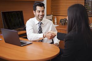 Family law attorney with client at desk