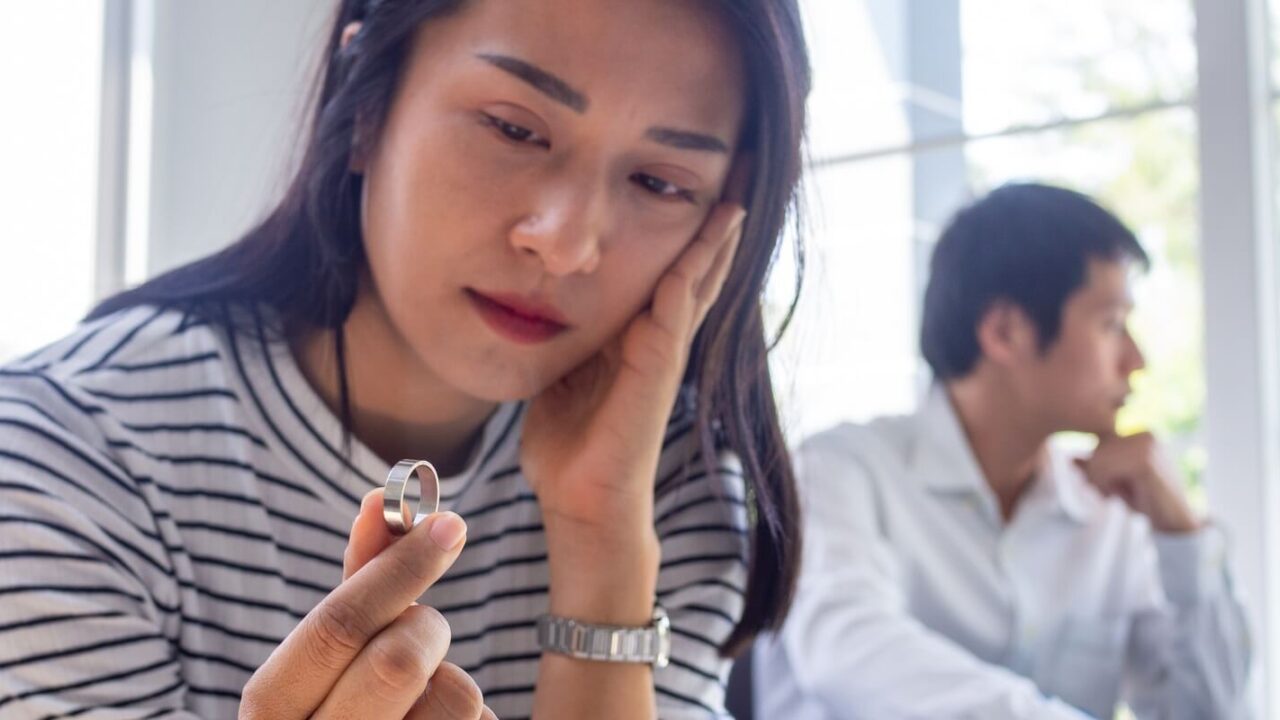 asian woman sat with the wedding ring