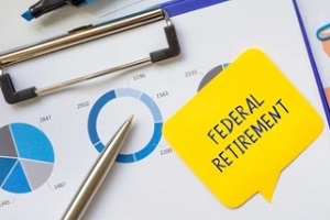 federal retirement on sticky note with graphs on clip board