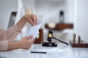 woman holding envelope with alimony