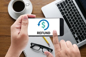 refund and tax refund fine duty taxation message on hand holding to touch a phone