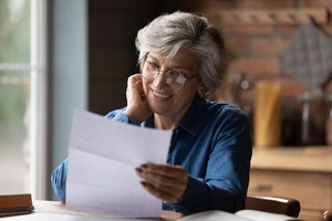 woman in glasses sit at table manage paperwork