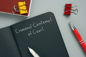 concept meaning criminal contempt of court with sign on the page