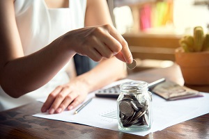 women savings coin in jar