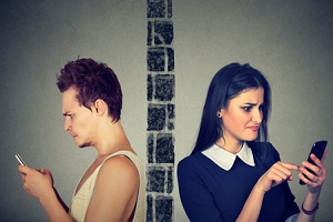 couple thoughtful upset man and woman separated by wall tasting each other on mobile phone