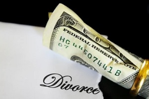 divorce paper with dollar and ring
