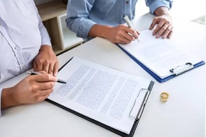couple signing divorce agreement