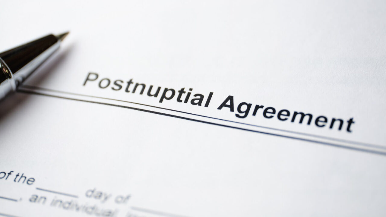 legal document postnuptial agreement on paper with pen