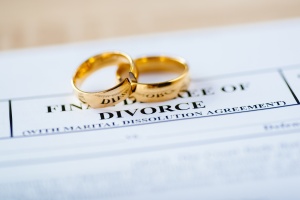 Two broken golden wedding rings A difficult negotiation for couple going through Uncontested Divorce decree document