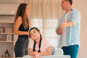 little upset girl with parent arguing