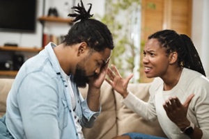 angry african american couple arguing over divorce on sofa in the living room