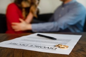 divorce decree document with man calms down a woman on the background