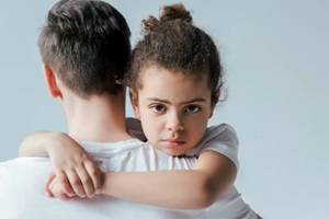 back view of foster father taking away upset african american daughter isolated on white