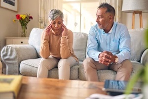 couple, fight and divorce in stress, conflict or argument from disagreement on living room sofa at home