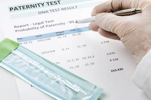 doctor points at result on paternity test result form